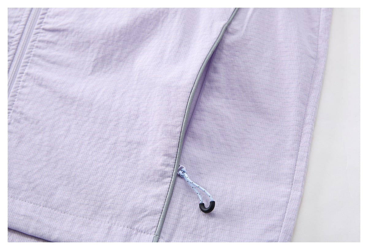 Close-up of gray piping and a light blue drawcord with a black hook on the pale lavender jacket.