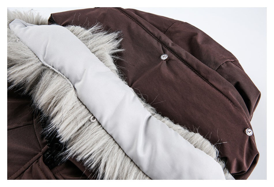 Close-up of the dark brown jacket with its fur-trimmed hood folded back, exposing a pale lining and buttons.