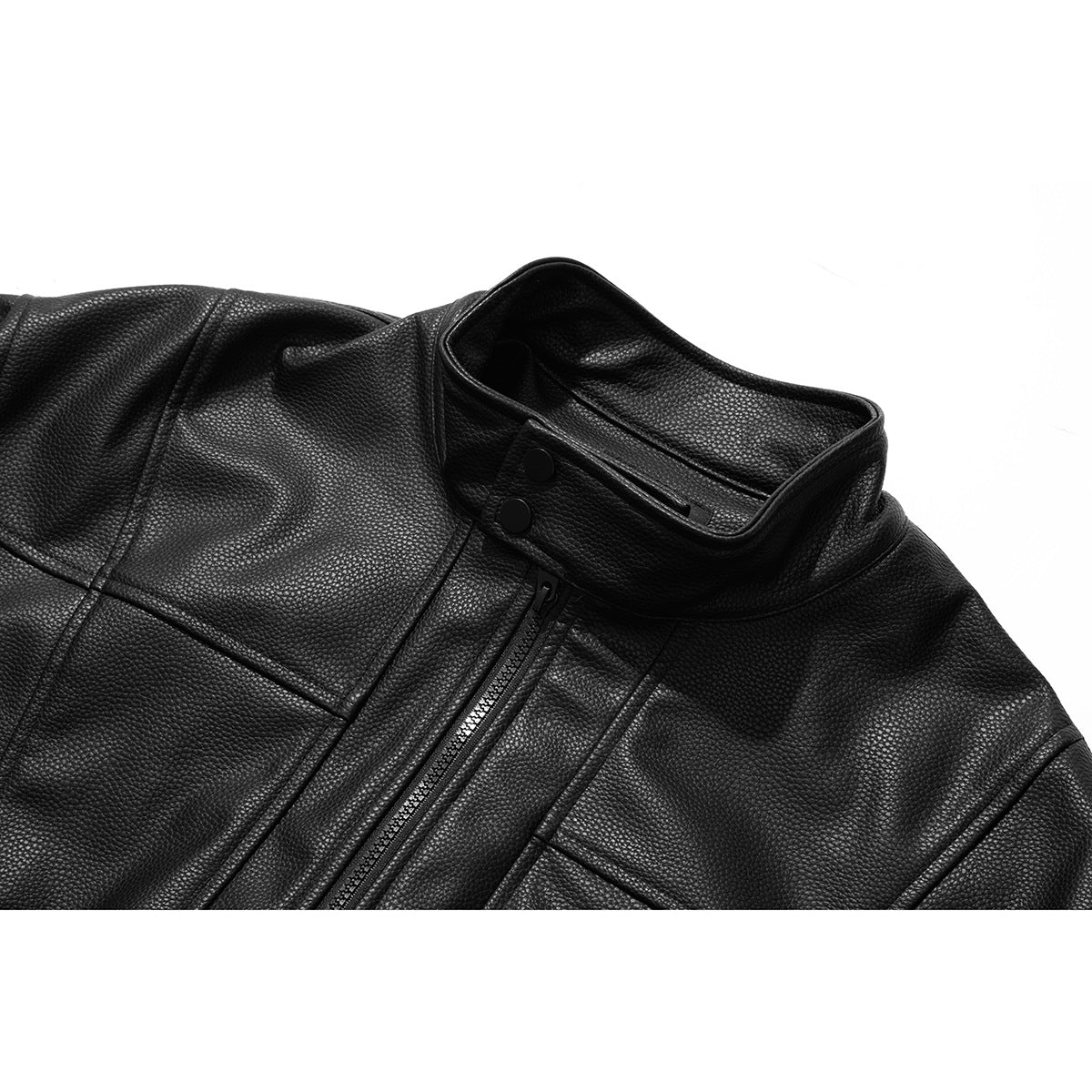 Close-up of a black pebbled jacket showing its stand collar, snap tabs, zipper and chest seams.