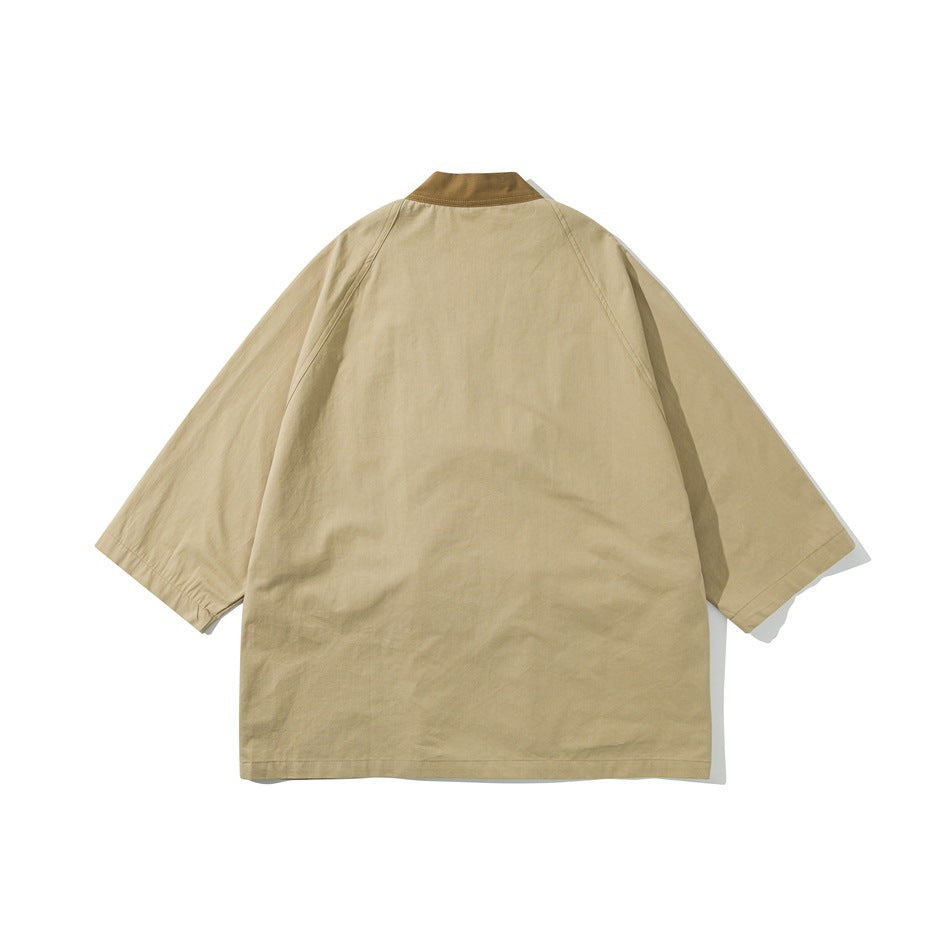Back view of khaki jacket with brown collar band and raglan three-quarter sleeves, flat lay