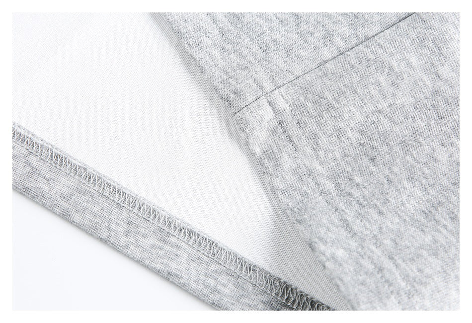 Inside view of a light gray garment seam with visible overlock stitching.