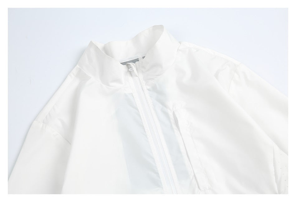Close-up of the white windbreaker’s raised collar, zipper, and upper chest.