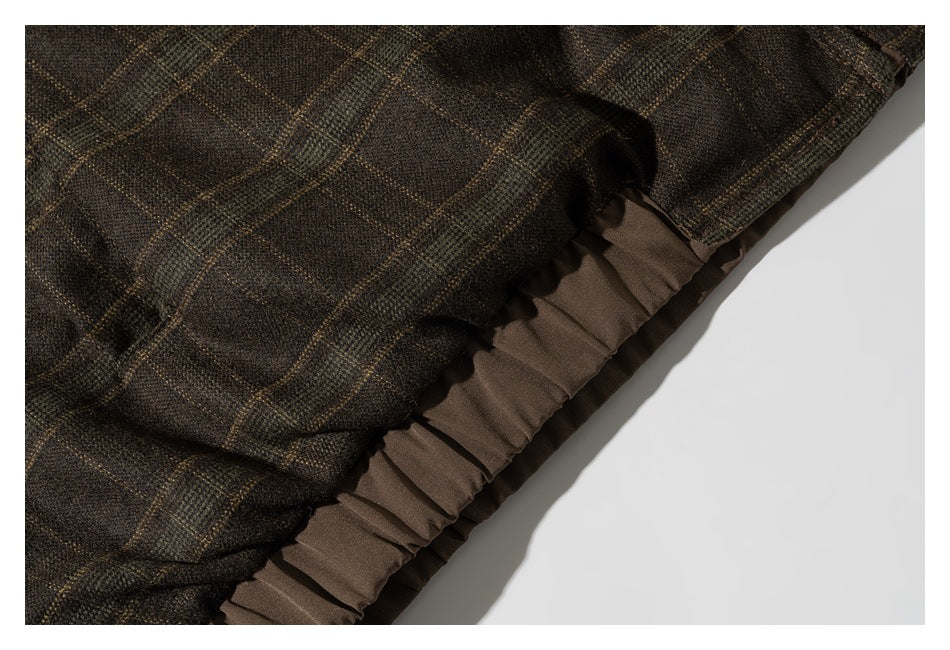 Close-up of a dark brown windowpane-plaid garment with a brown pleated lining or trim.