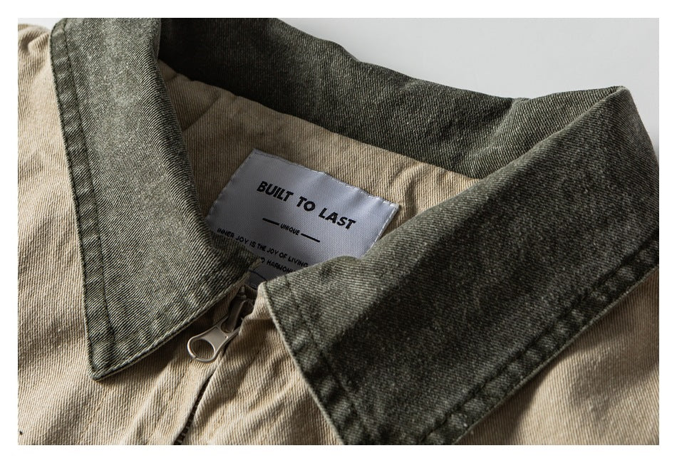 Close-up of a beige jacket collar, zipper pull, and sewn-in label reading “BUILT TO LAST.”
