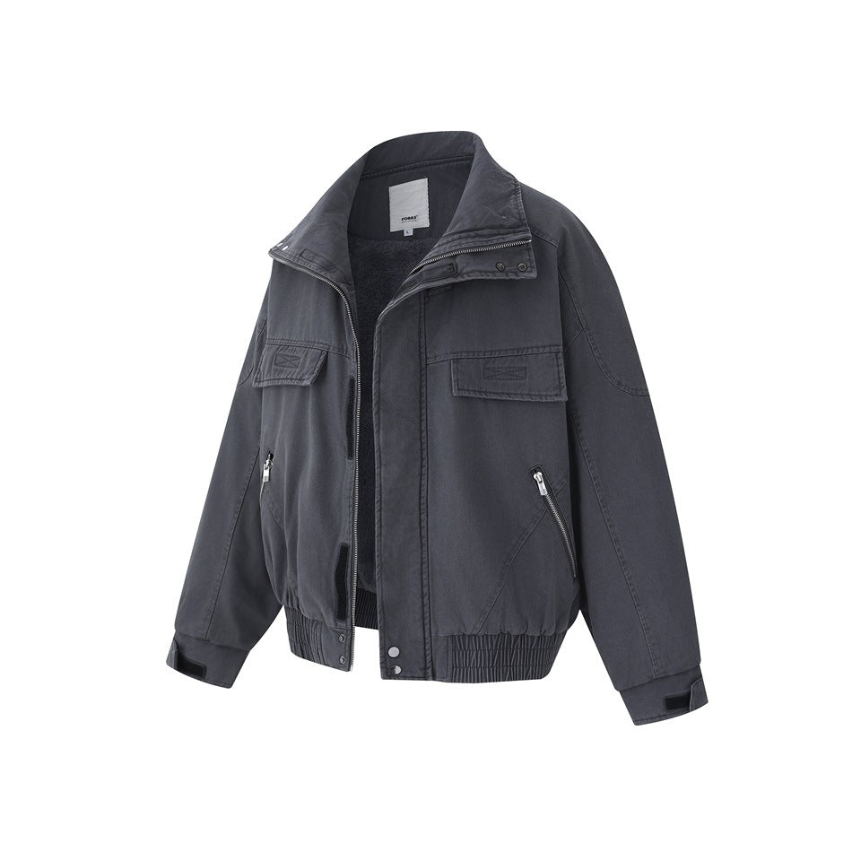 Charcoal jacket with a stand collar, zip front, chest flap pockets, angled zip pockets and an elastic hem.