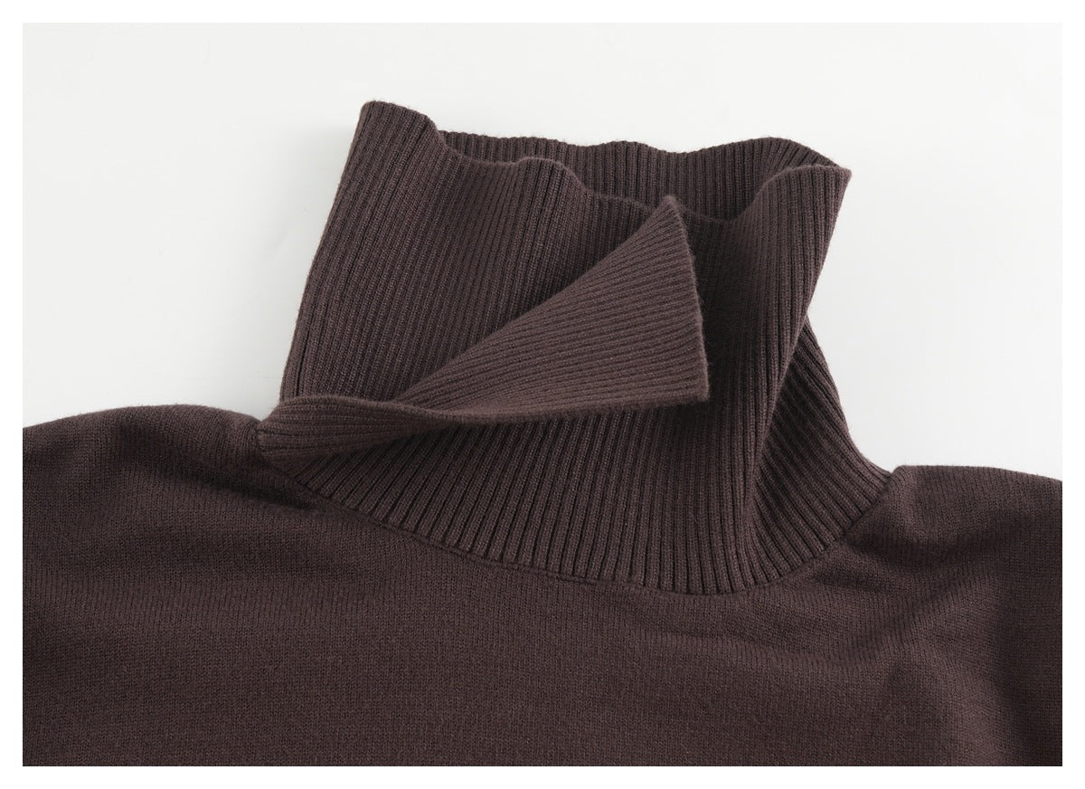 Close-up of a dark brown sweater's tall ribbed collar, partly folded to show the neckline.
