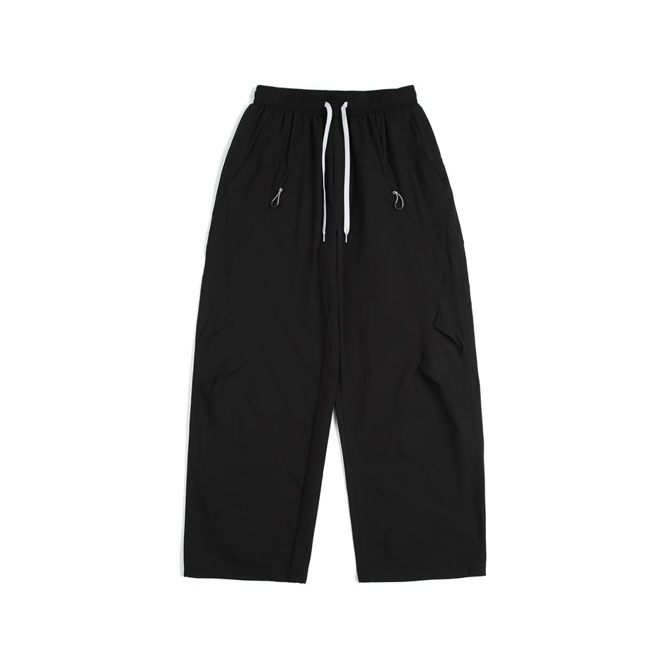 Black wide-leg drawstring pants with diagonal seams and hip pockets, flat lay front view