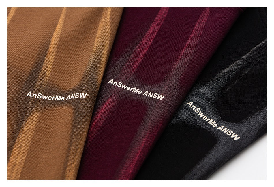 Close-up of brown, burgundy, and black striped garments with white AnSwerMe lettering.