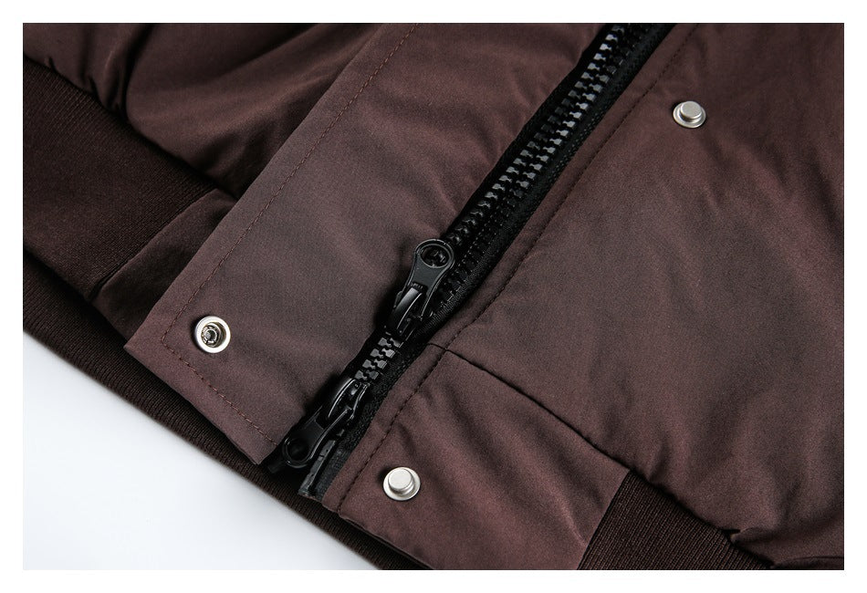Close-up of a dark brown jacket with a black zipper, silver snaps, and ribbed cuff.