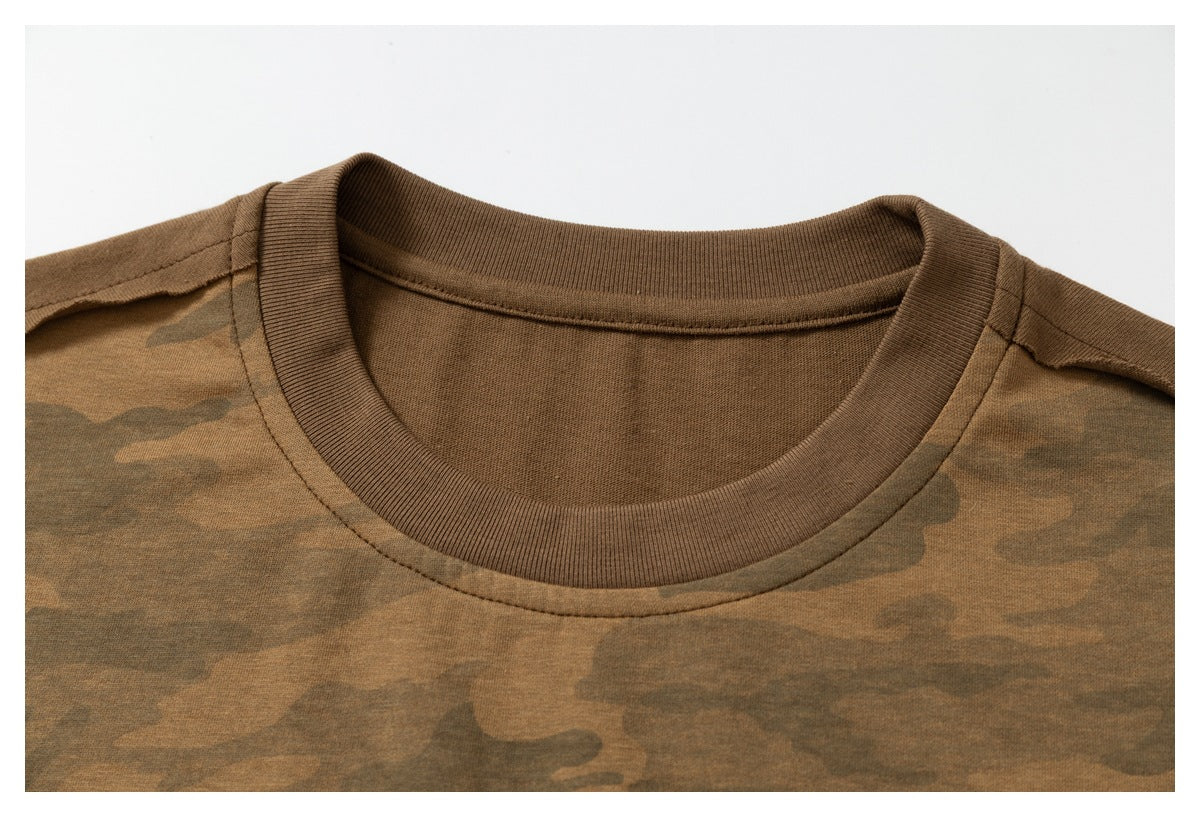 Close-up of a brown crew neck and shoulder seams on a brown camouflage T-shirt.