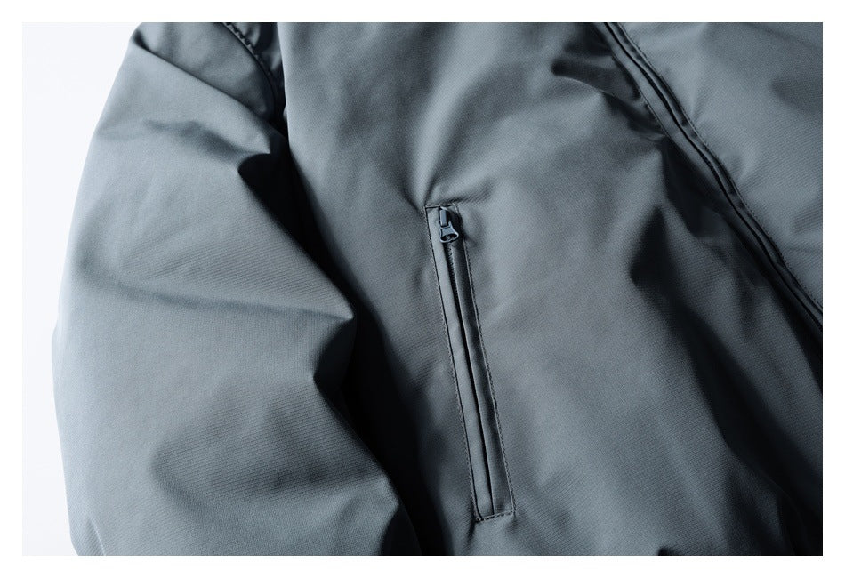 Close-up of the jacket's vertical zip pocket and sleeve in charcoal gray.