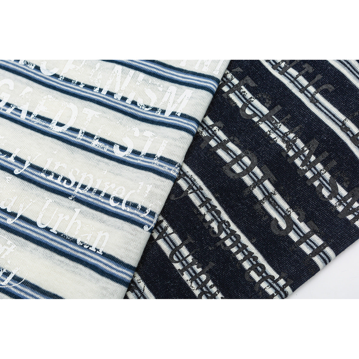 Close-up of ivory and dark navy striped garment fabric with distressed English lettering.