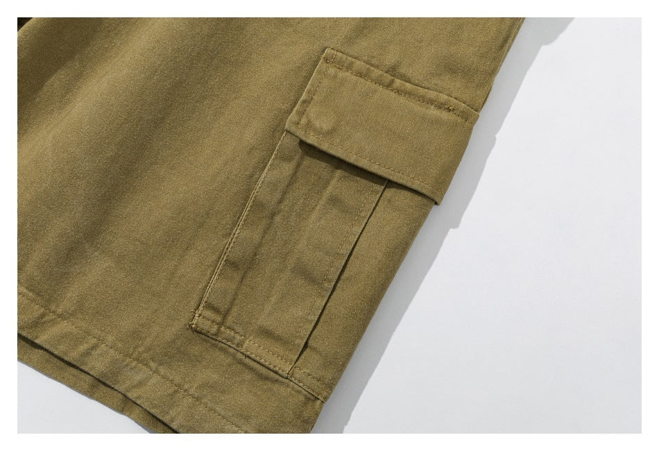 Close-up of an olive-khaki cargo shorts leg with a large flap cargo pocket.