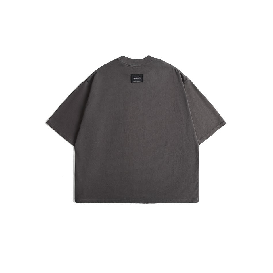Back view of an oversized charcoal gray T-shirt with short sleeves and a small black neck label.