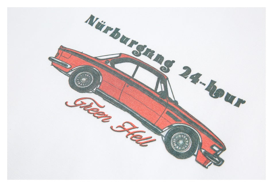 Close-up of a red vintage car graphic and English lettering printed on a white T-shirt.