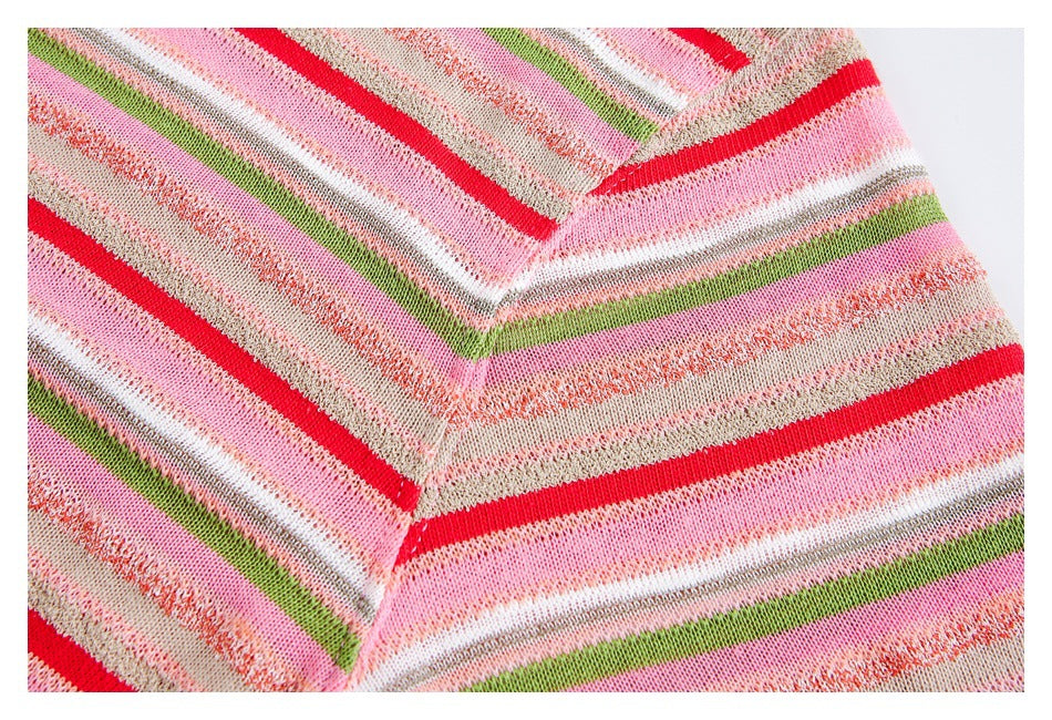Close-up of a V-shaped knit join with multicolored stripes in pink, red, green, white, and beige.