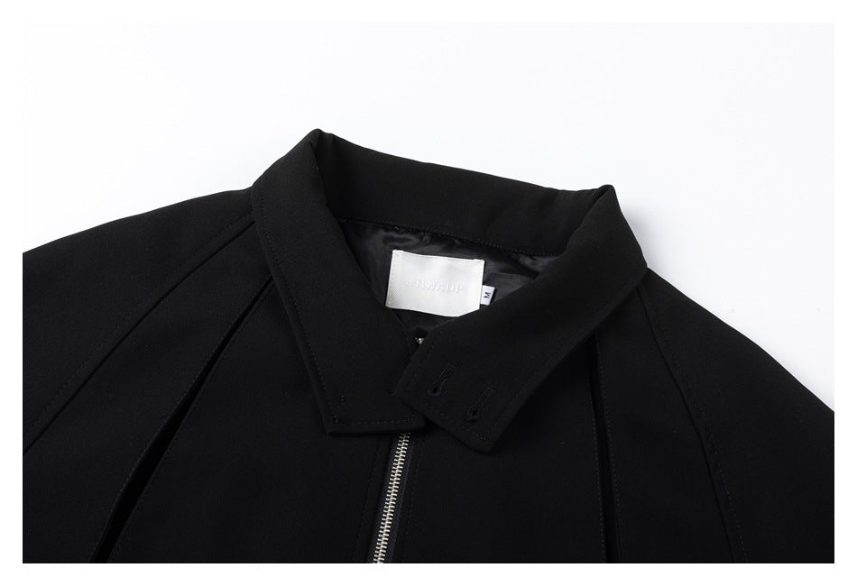 Close-up of the black jacket's collar, shoulder seams, silver zipper, and inner neck label.