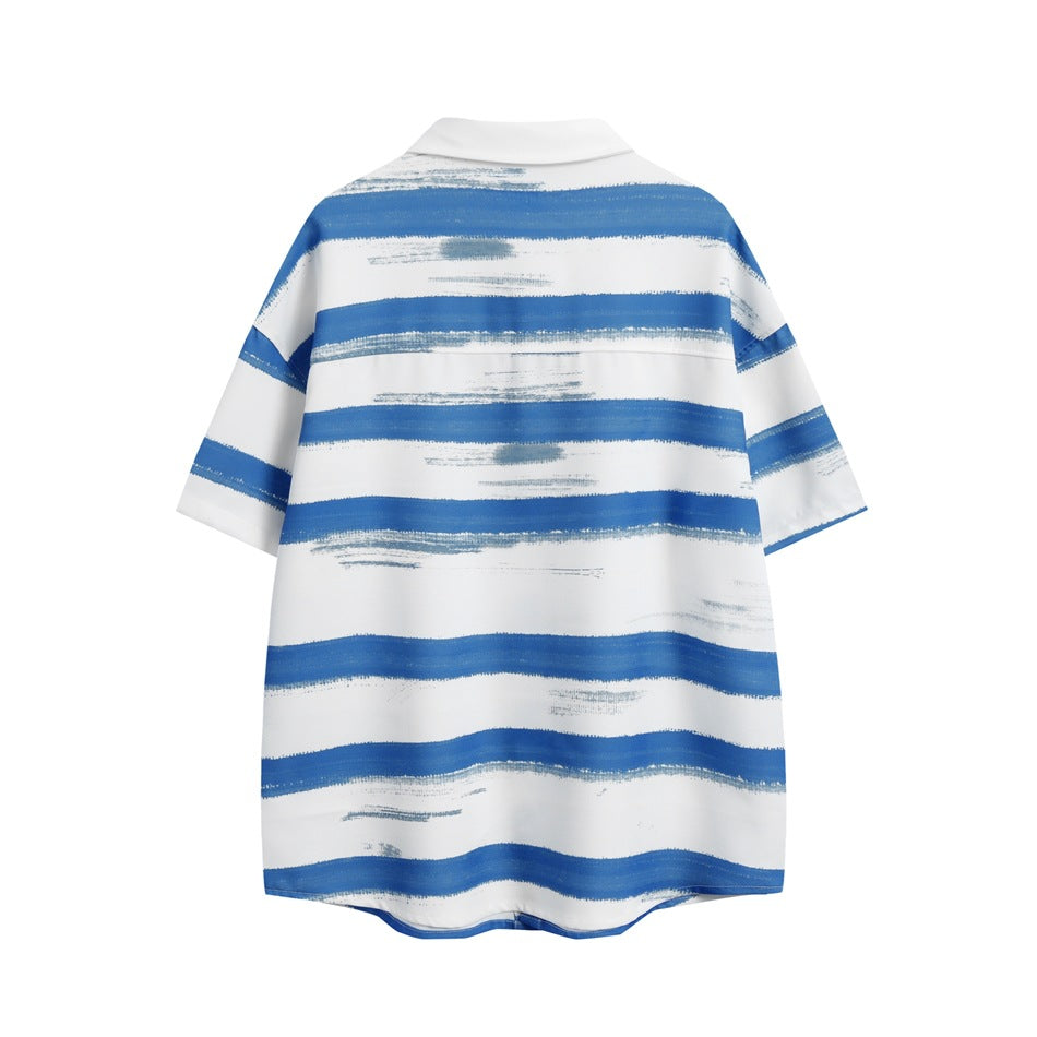 Back view of a white short-sleeve collared shirt with irregular horizontal blue brushstroke stripes.
