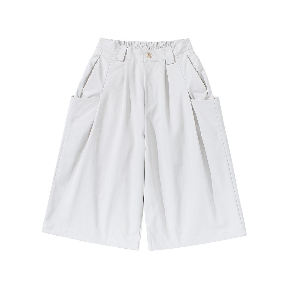 Off-white wide-leg pleated knee-length shorts with large side pockets and button front, flat lay