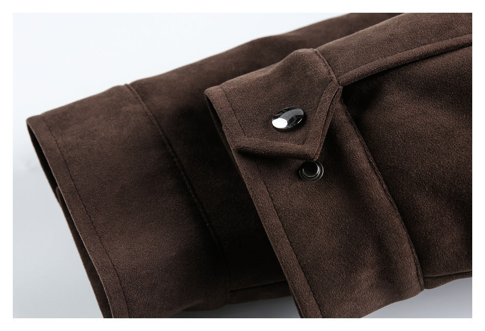 Close-up of the dark brown coat's sleeve cuff with a snap-button tab.