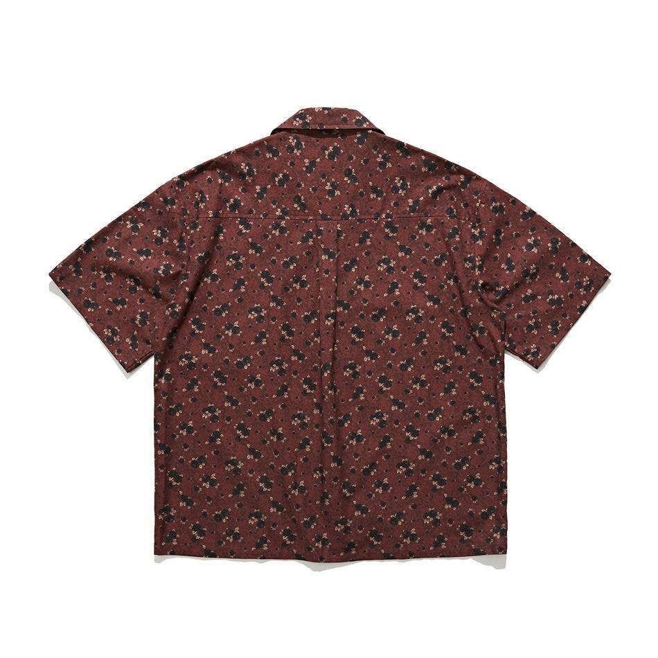 Back view of dark red floral print short-sleeve shirt with yoke seam and center pleat, flat lay