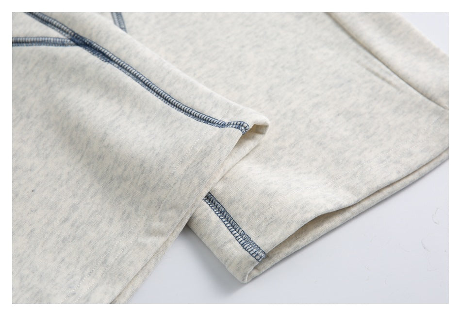 Close-up of the jogger leg opening and hem with blue-gray overlock stitching.
