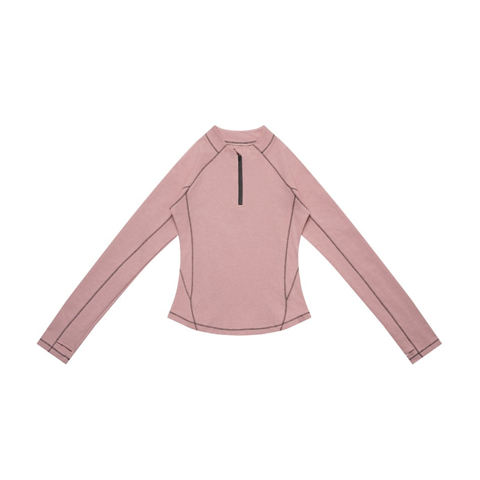 Pink long-sleeve half-zip top with gray contrast stitching and zipper, laid flat, front view