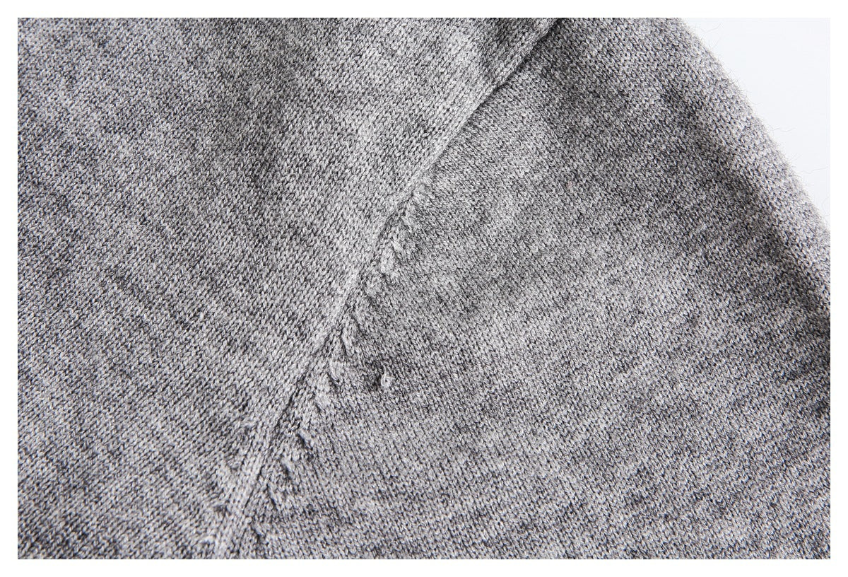 Close-up of gray marled knit fabric with a diagonal seam.