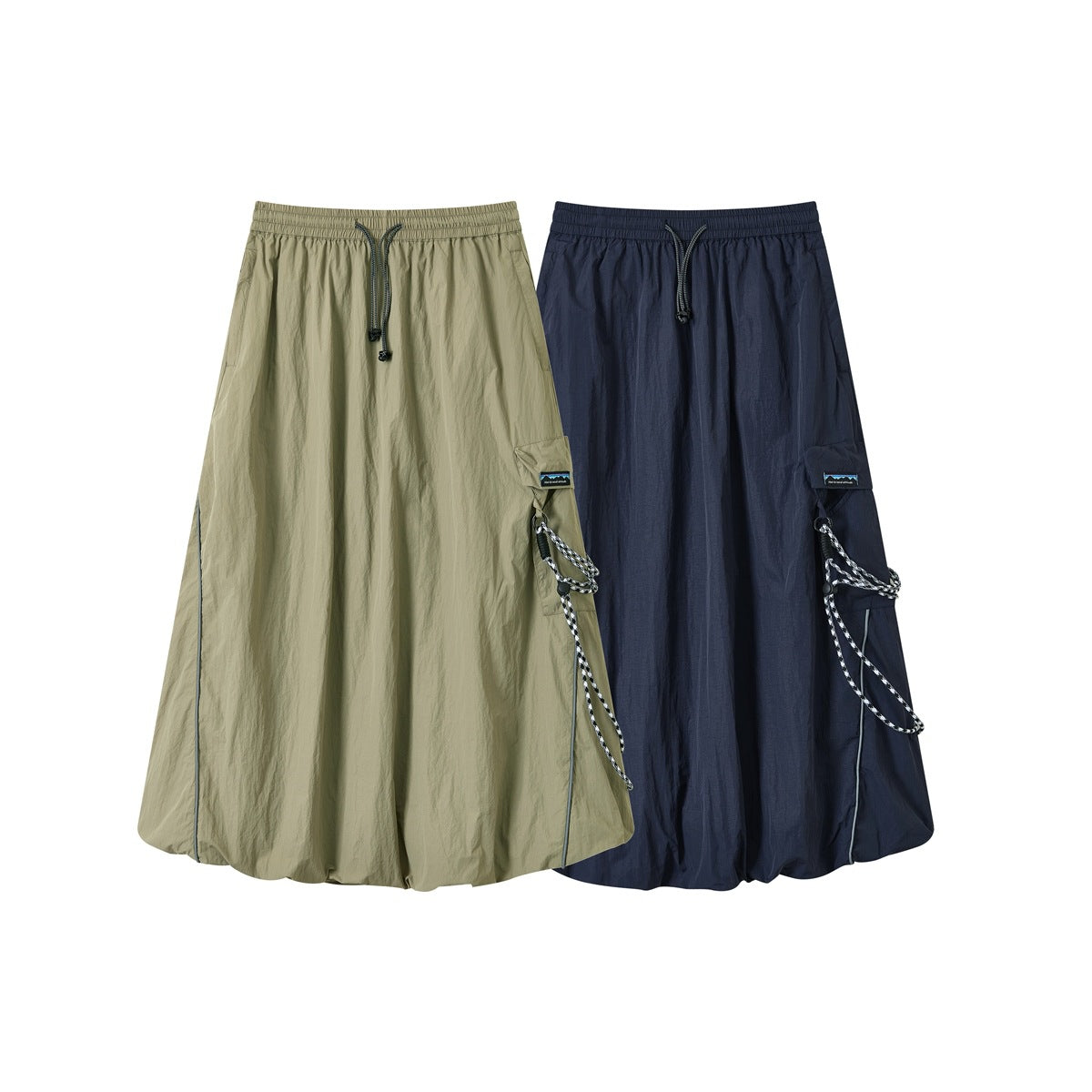 Two long utility skirts shown from the front in khaki and navy, with elastic waists, drawcords, and side cargo pockets.