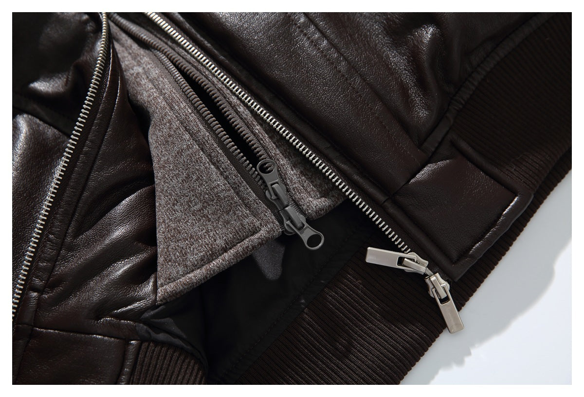 Close-up of an open dark brown jacket showing dual zippers, a contrasting inner layer, and ribbed trim.