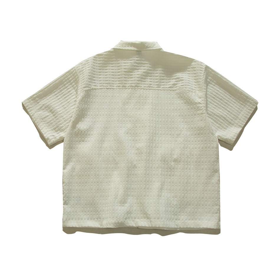 Back view of cream-white short-sleeve textured shirt showing back yoke seam, flat lay