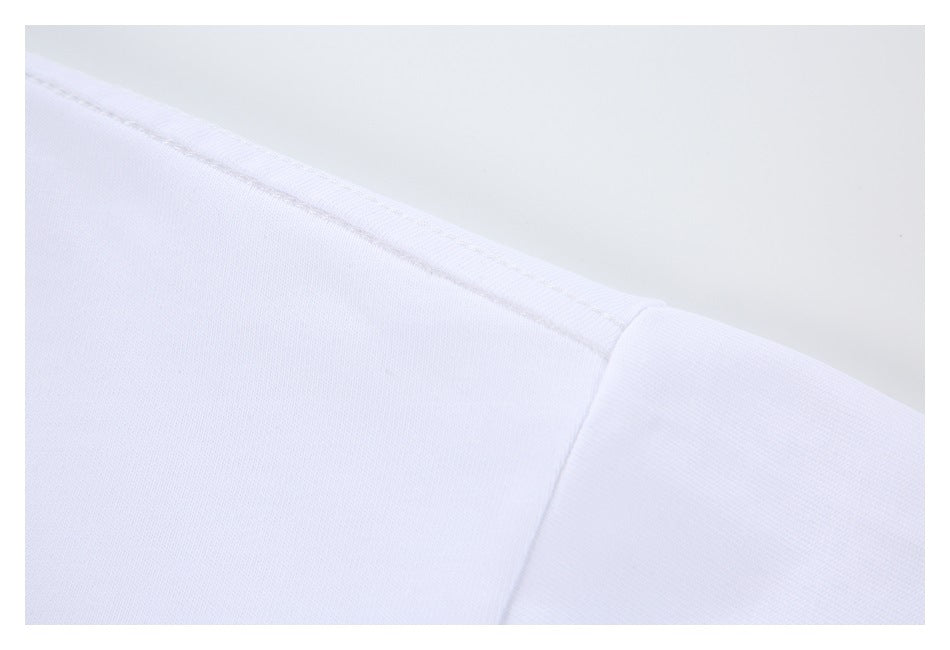 Close-up of the white T-shirt's shoulder seam and sleeve attachment.