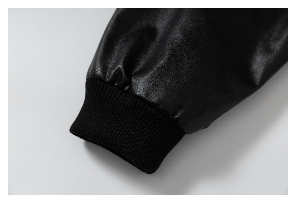 Close-up of a glossy black sleeve gathered into a wide ribbed cuff.