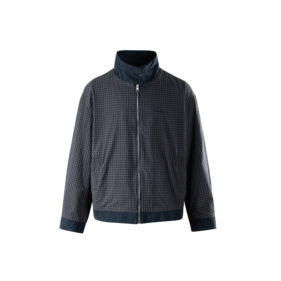 Front view of a long-sleeved jacket with a small dark check pattern, navy collar, cuffs, hem, and center zipper.