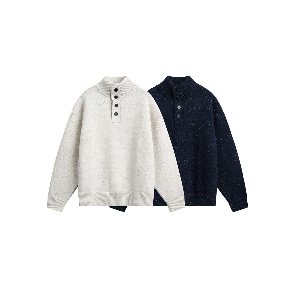 Front view of two speckled knit sweaters, one cream and one navy, with stand collars and button plackets.