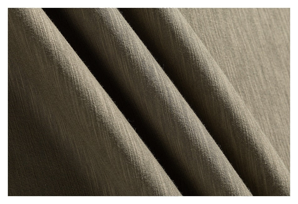 Macro view of olive-gray sweatshirt fabric draped into folds, showing its surface texture.