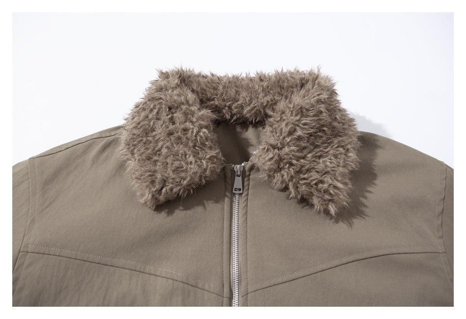Close-up of a taupe jacket with a thick curly faux-fur collar and silver front zipper.