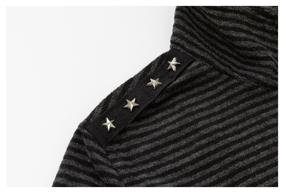 Close-up of silver star studs on a black shoulder strip over the jacket's charcoal and black stripes.