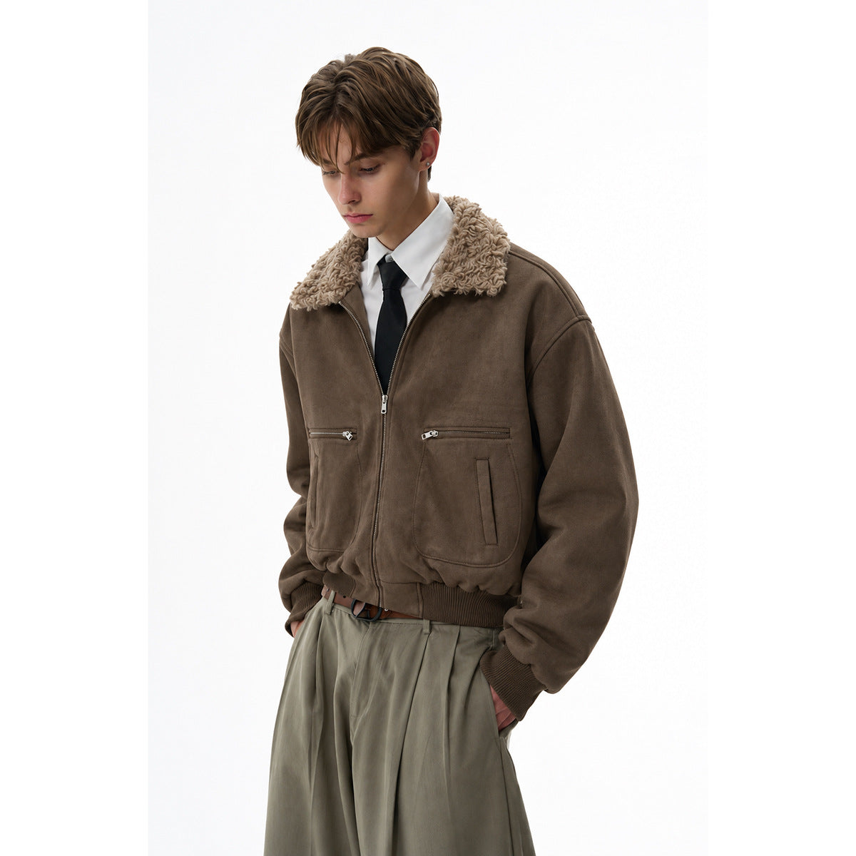 Model wearing a dark brown zip jacket with a plush tan collar and ribbed hem, styled with a white shirt and tie.