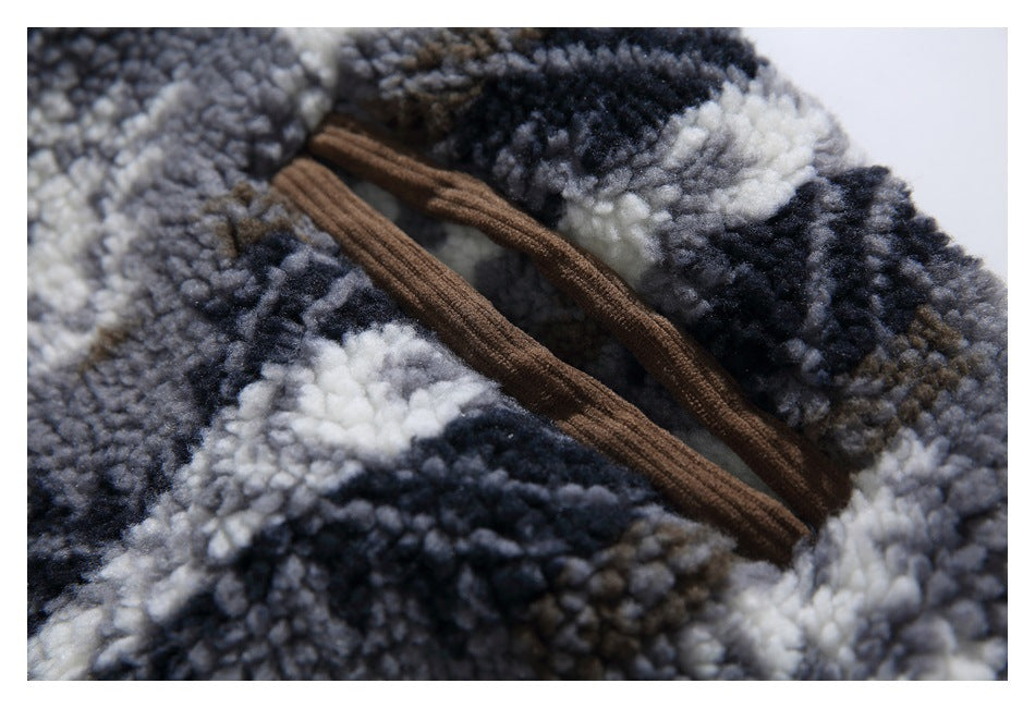 Close-up of a brown-trimmed pocket opening on the jacket's plush patterned fleece.