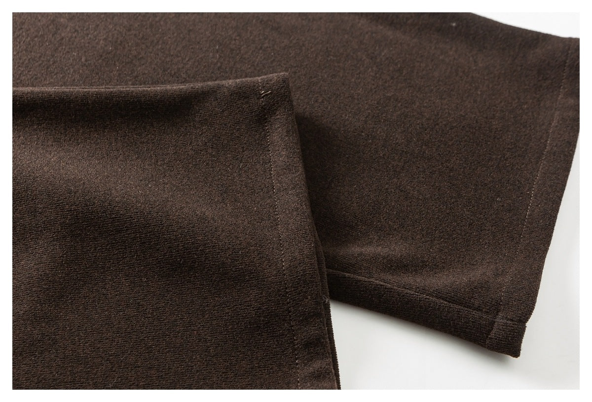 Close-up of dark brown pant legs showing stitched hems and the textured fabric.