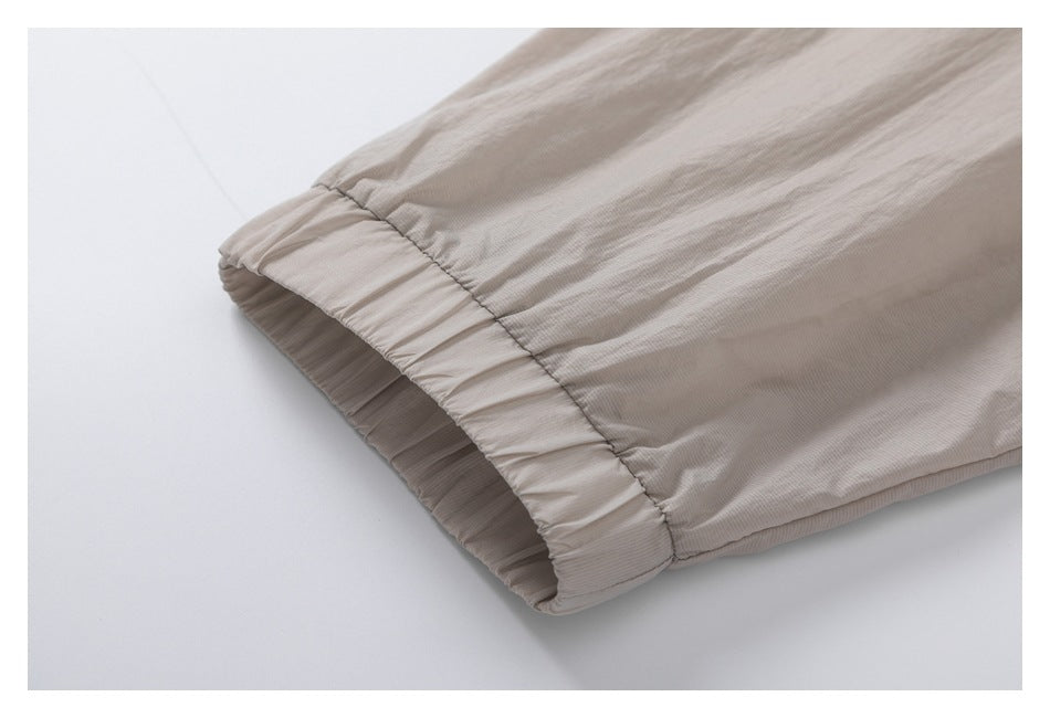 Close-up of a taupe sleeve with a gathered elastic cuff.