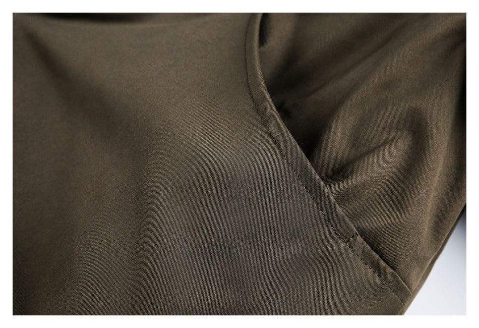Close-up of the jacket fabric and curved seam at the sleeve and body.