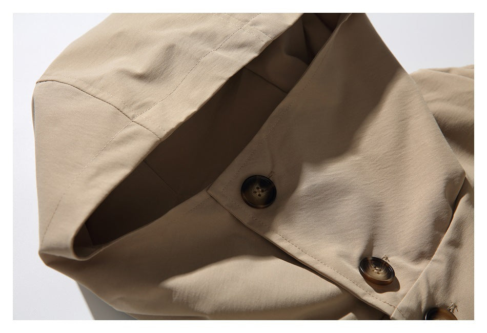 Close-up of a beige coat's wide collar and dark buttons.