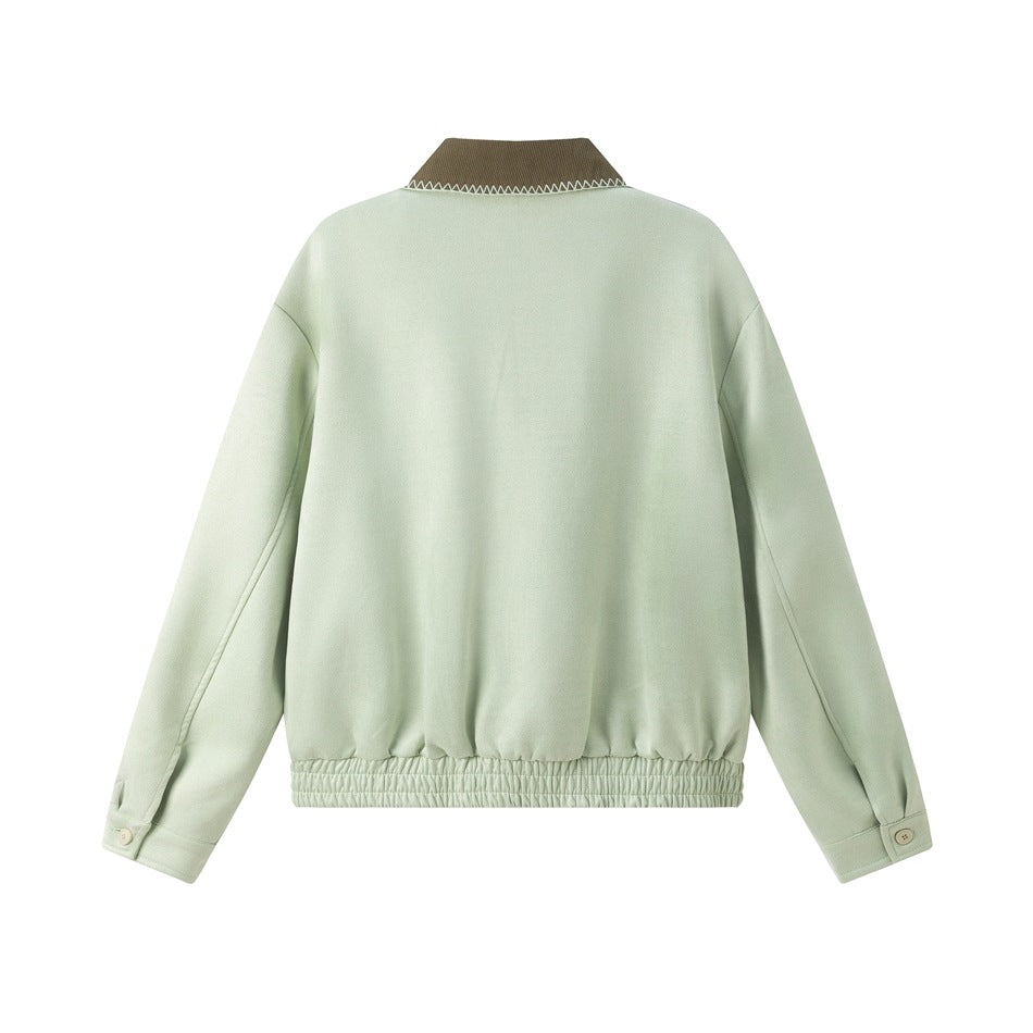 Back view of a pale mint jacket with a brown collar, long sleeves, button cuffs, and gathered hem.