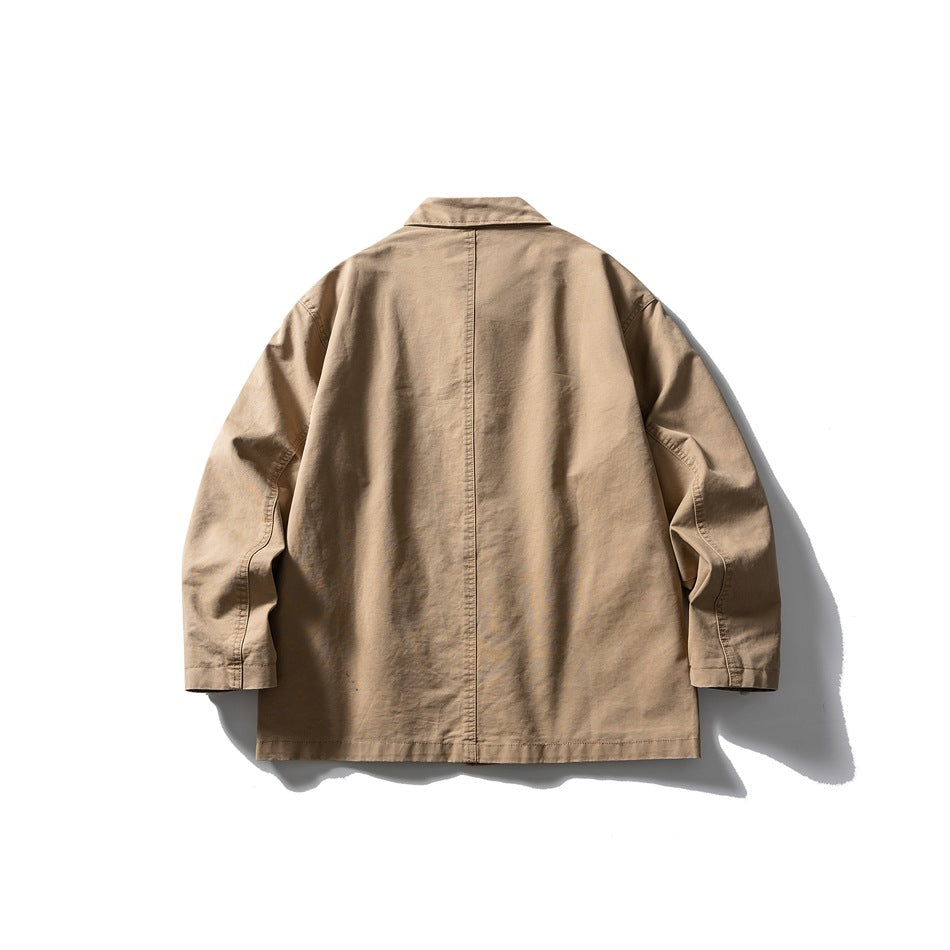 Back view of a tan collared jacket laid flat, with long sleeves and a central back seam.