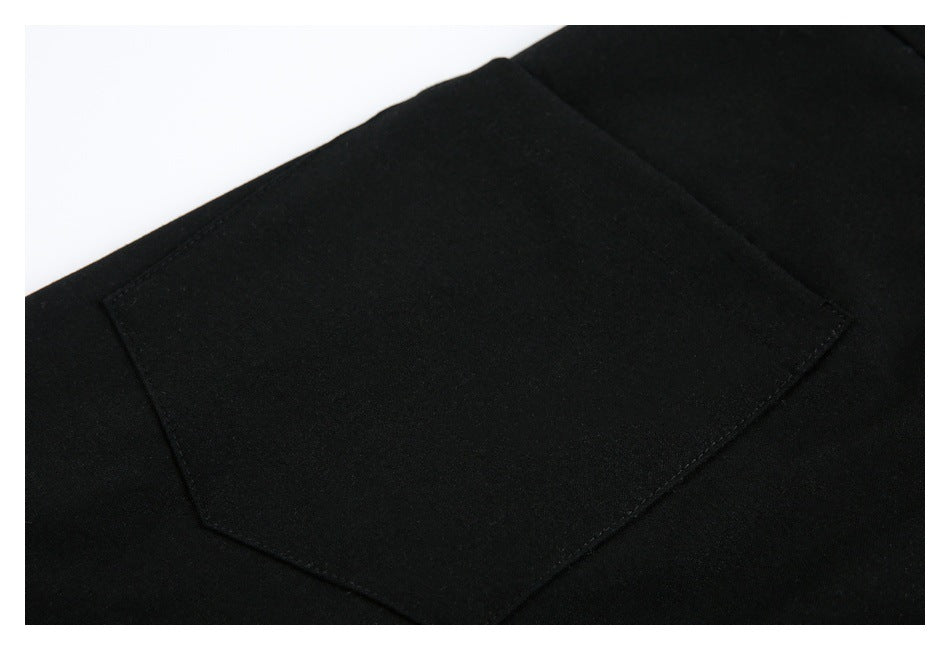 Close-up of a rectangular back pocket on black trousers.