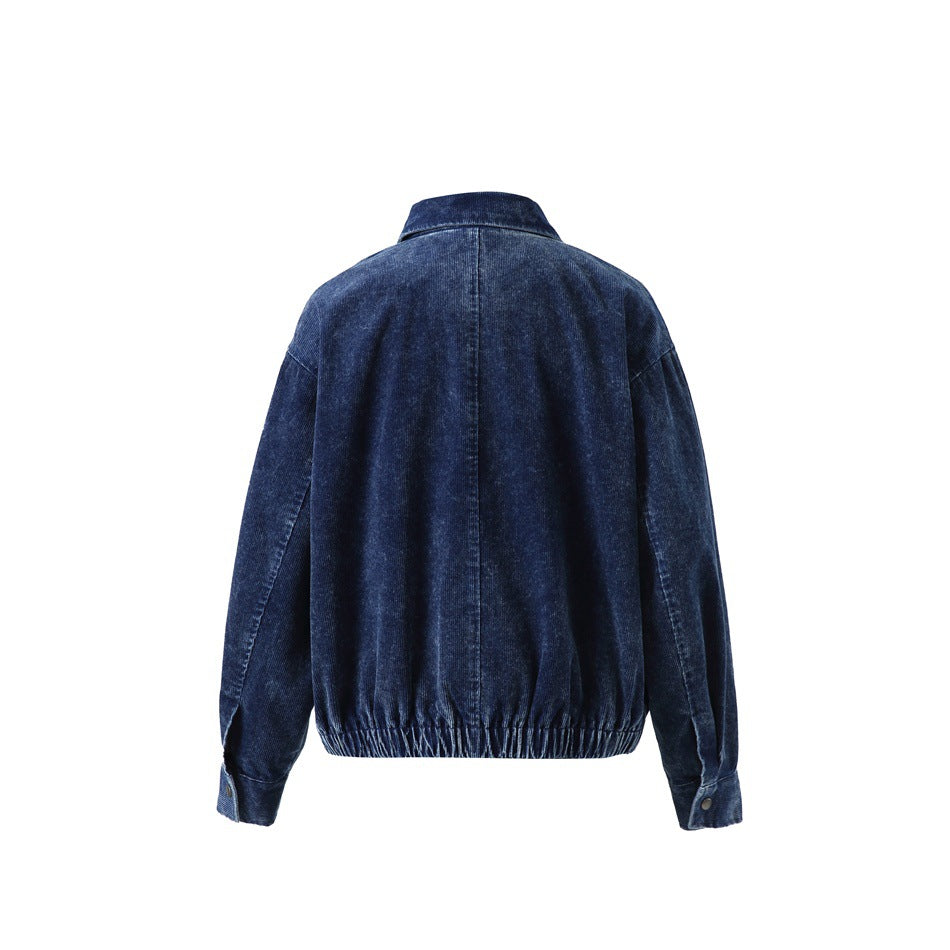 Back view of a dark navy jacket with a center seam, long sleeves, and an elasticized hem.