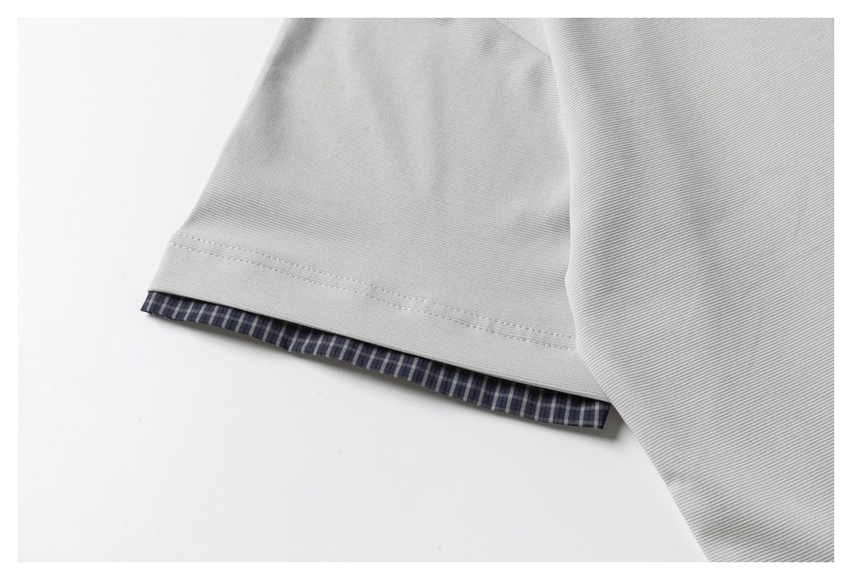 Close-up of the gray polo sleeve hem with a narrow navy checked lining visible at the edge.