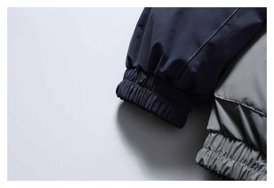 Close-up of navy and gray jacket sleeves with gathered elastic cuffs.